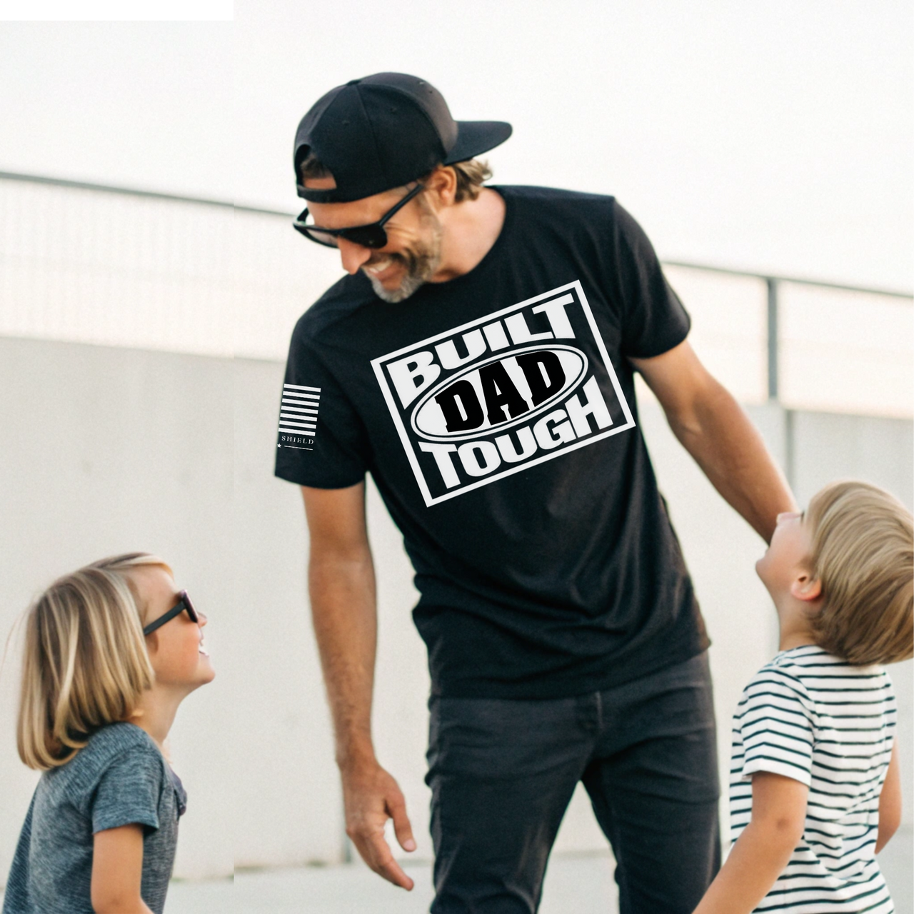 Hardworking dad wearing Built Dad Tough tee