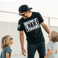 Hardworking dad wearing Built Dad Tough tee