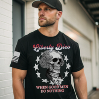 Man wearing a black t-shirt with a patriotic graphic design that says liberty dies when good men do nothing.