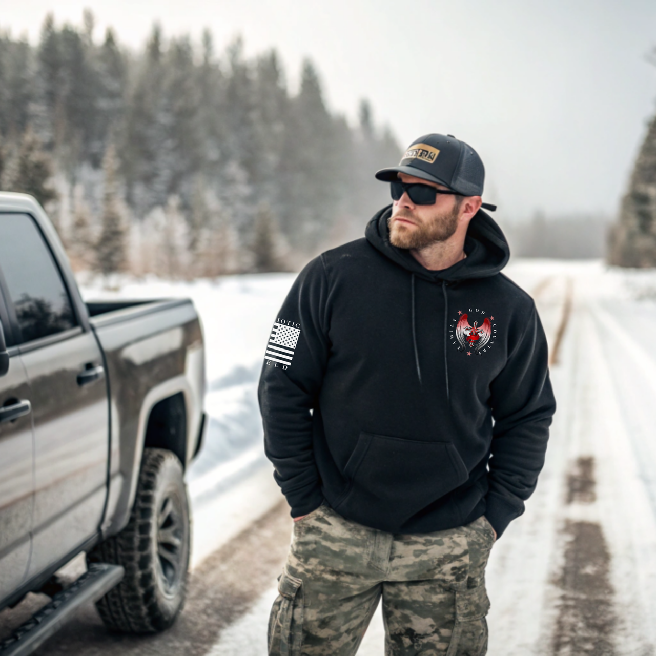 Veteran-family owned 'Family, God, Country' hoodie displayed on a man standing outdoors emphasizing the bold winged cross design and premium craftsmanship.