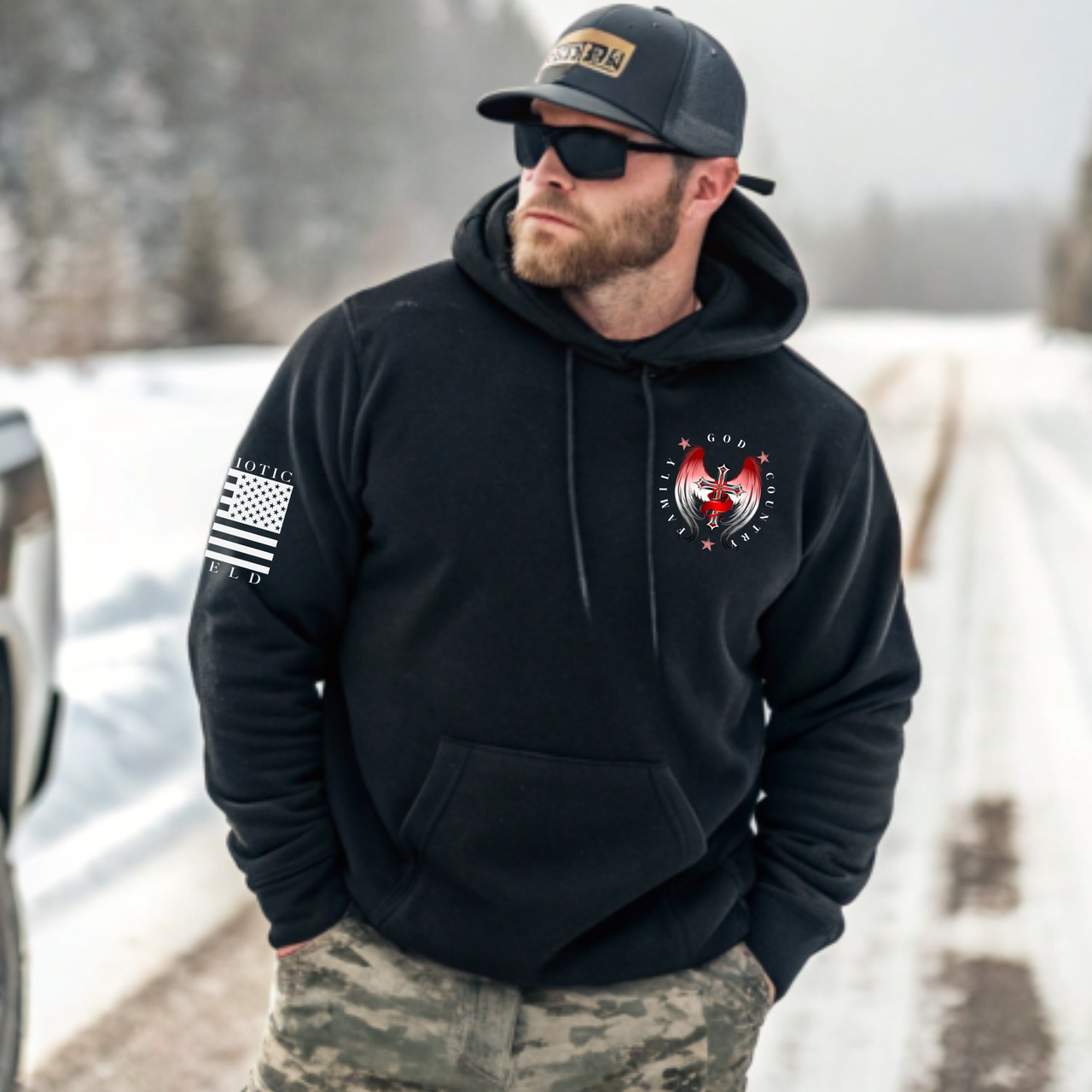 "Man standing outdoors wearing the 'Family, God, Country' hoodie, showcasing its intricate design and comfortable fit.