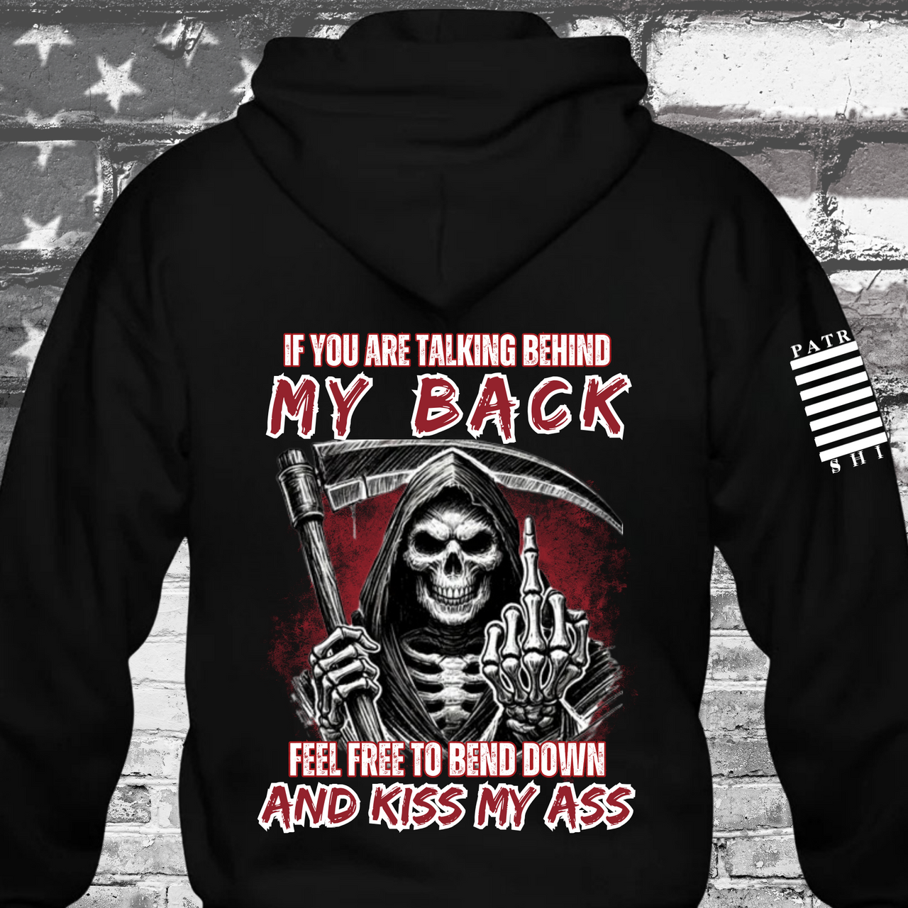 Black hoodie with bold text and the grim reaper giving the middle finger stating, "Talk behind my back, bend down and pkiss my ass," designed for patriotic rebels